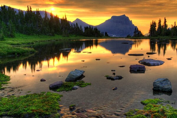 Clear mountain lake on the background of sunset