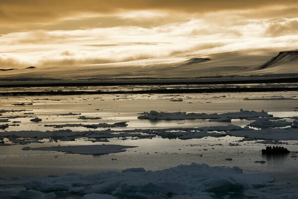 Mountain landscape with clouds and ice on the river