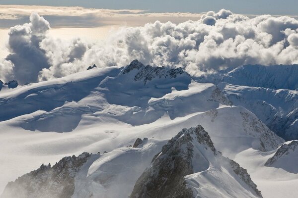 Snow-capped mountain peaks in the clouds