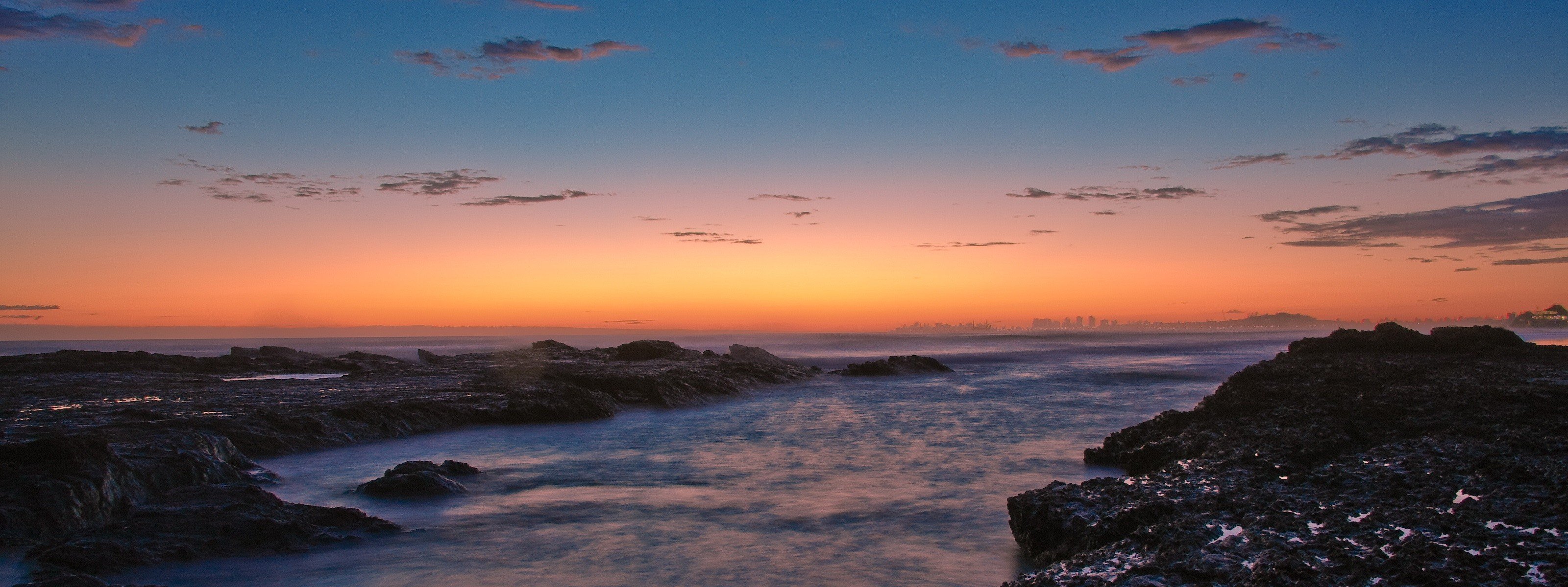 unset beach stones water