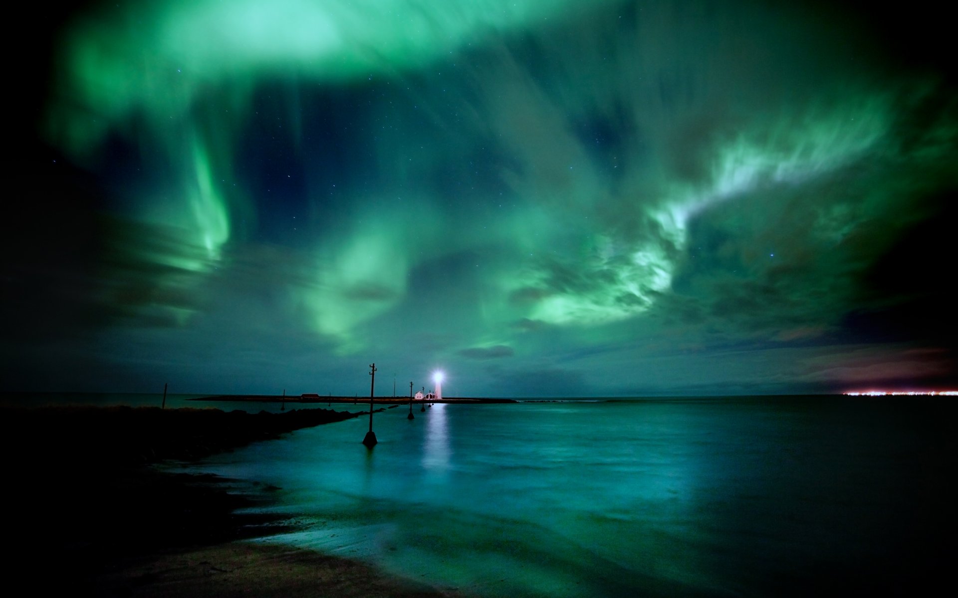 northern lights iceland night sea sky star water lighthouse