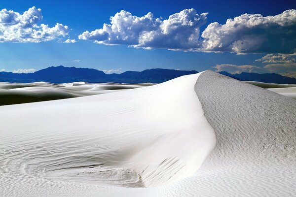 Snow-white sand. Beautiful clouds