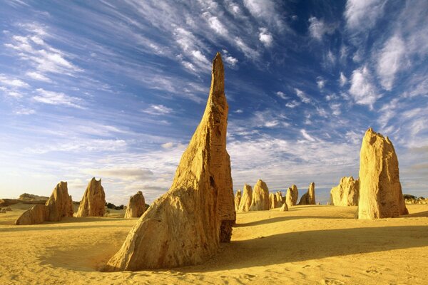 Figures made of sand. Blue clouds