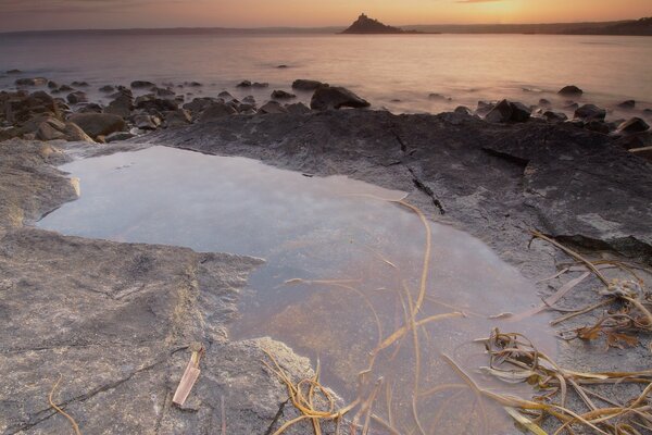 Flaque d eau sur le rivage parmi les pierres