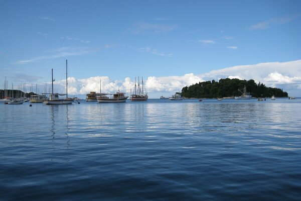 Yachts are moored next to the island