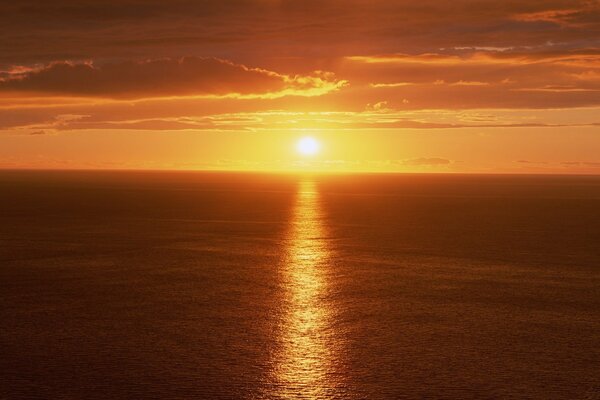 Sunset is reflected on the sea in the golden track video