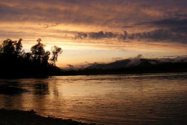 Flussufer im Hintergrund des Sonnenuntergangs