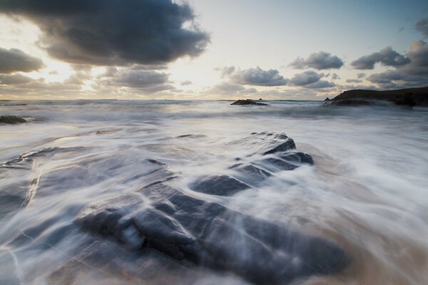 Water washes the rocky shore