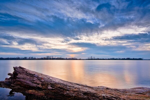 Beautiful sunset on the background of the lake