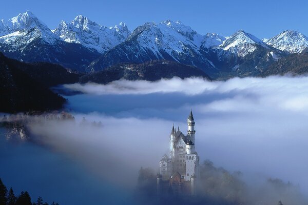 Mysterious castle in the mountains early in the morning in the fog