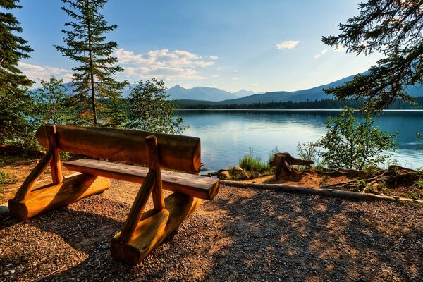 Bench by the lake ea against the sky. Canada