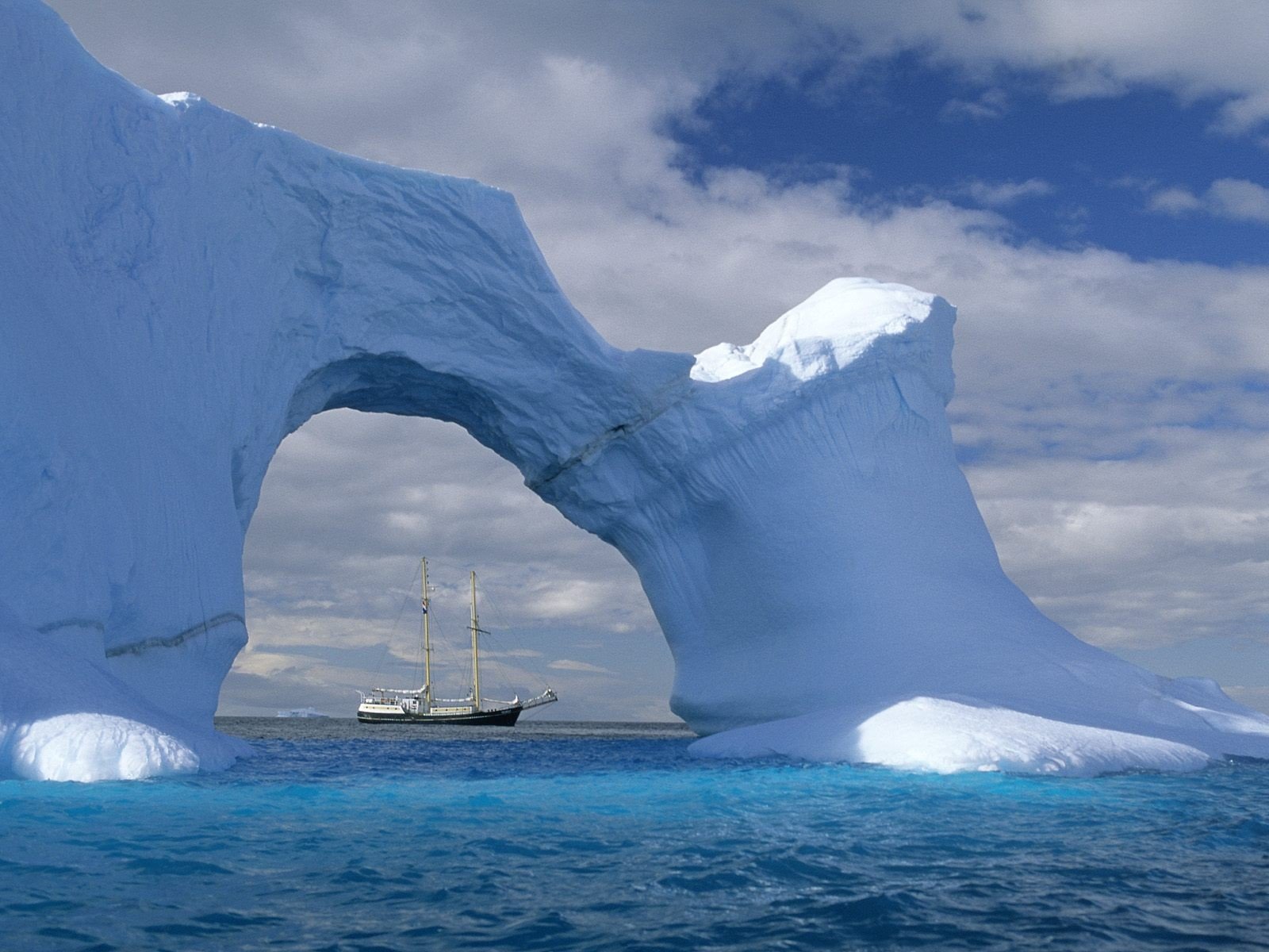 iceberg sailboats wave