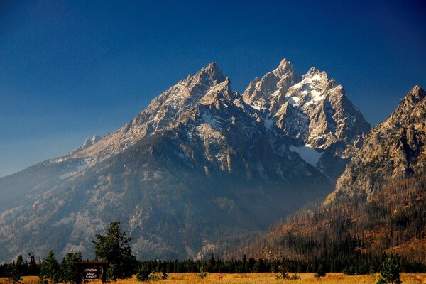 Snowy mountain peaks against the blue sky