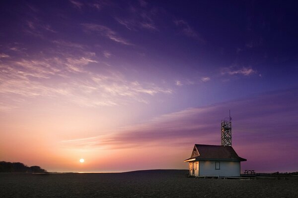 House on the shore. Sunset