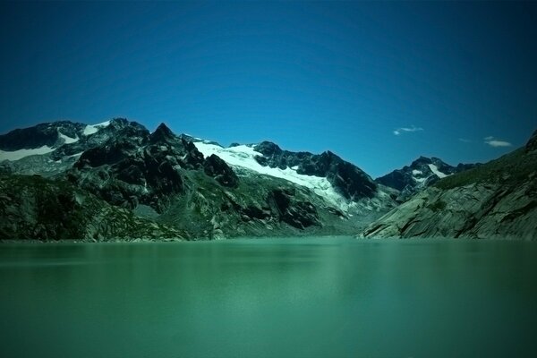 Grüner See in der Nähe der Berge