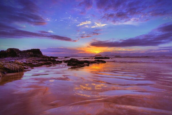 The stone coast is drowned in clouds in the sky