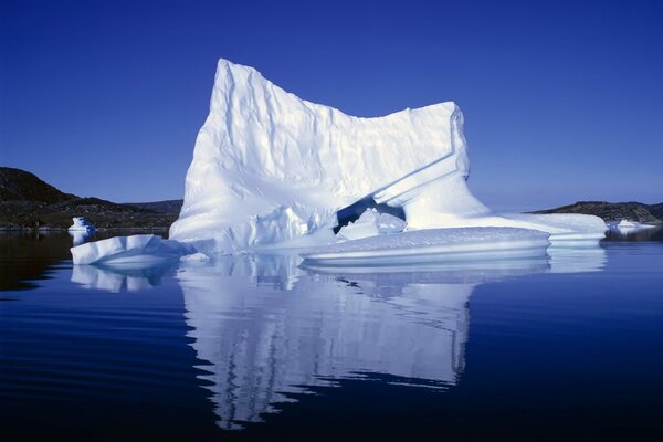 A large iceberg in calm water