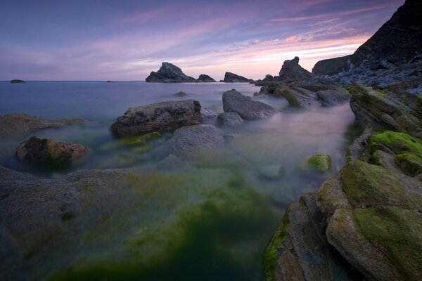 Rocky shore against the sunset sky