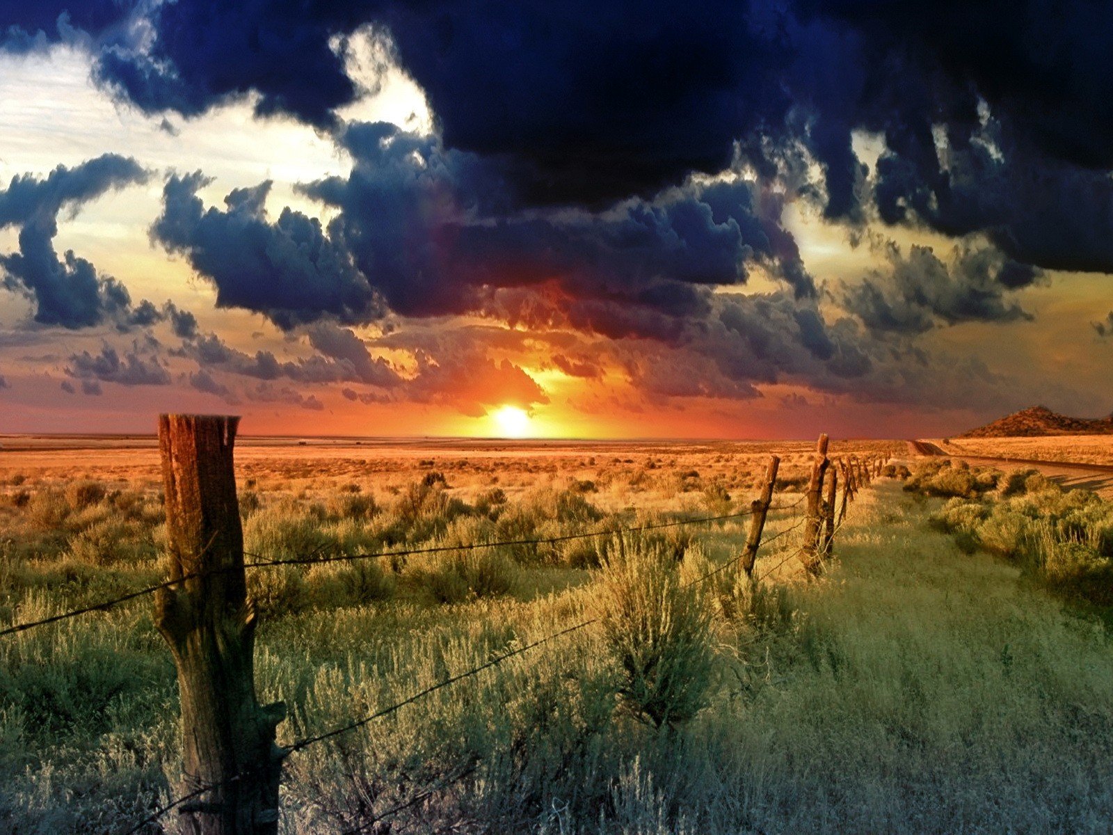 fence sun clouds the field