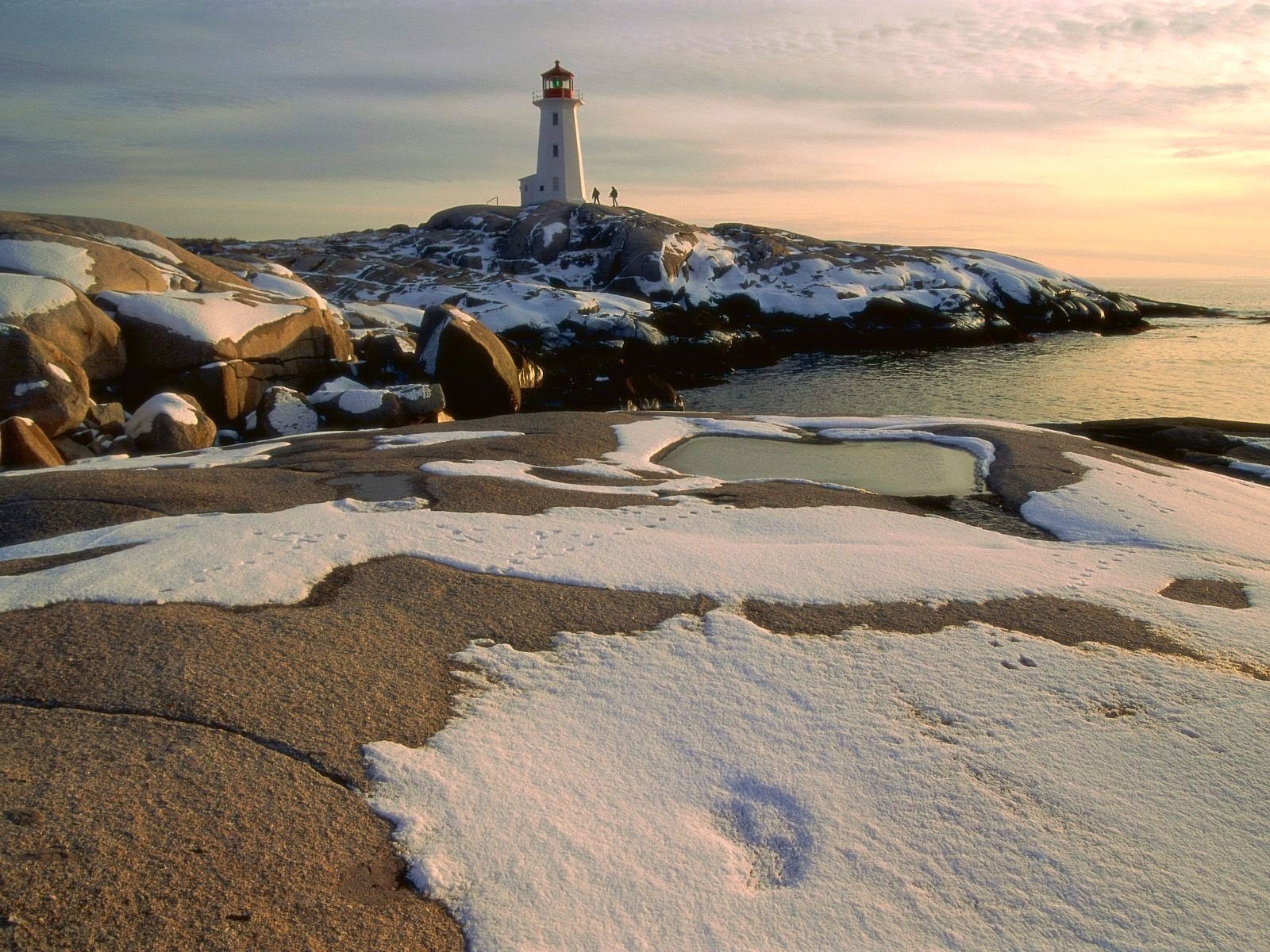 lighthouse snow stones people