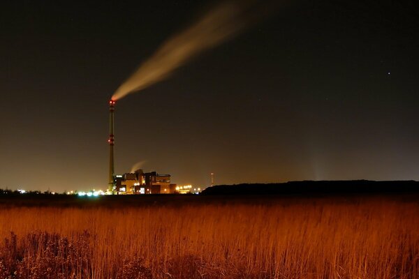 A lonely factory with smoke from a chimney