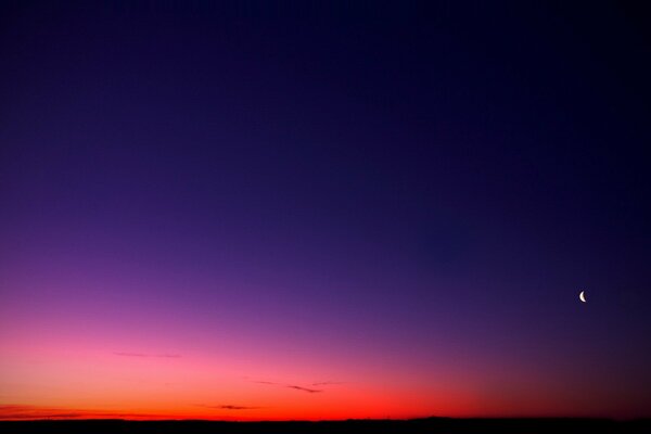 Sky gradient with the moon at sunset