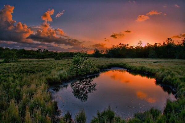 Puesta de sol naranja en el reflejo del agua