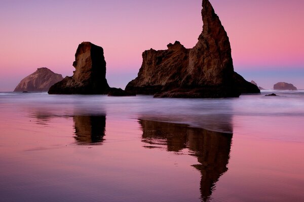 Reflection of the rocky shore in the rose water