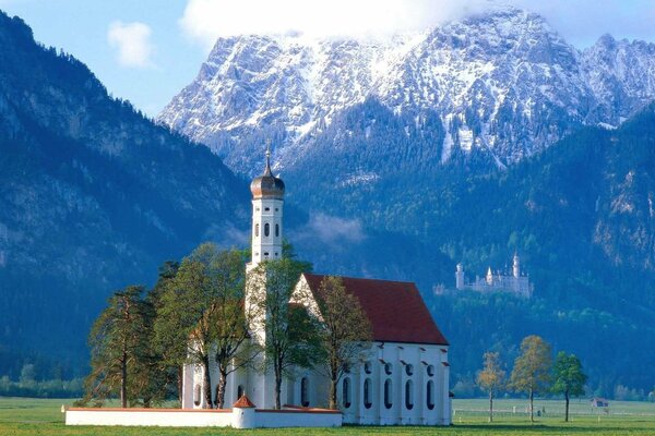 Church with a red roof in the mountains