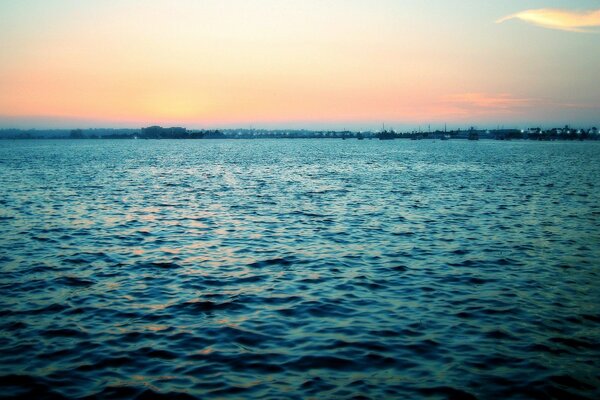 The endless blue sea in the sunset rays