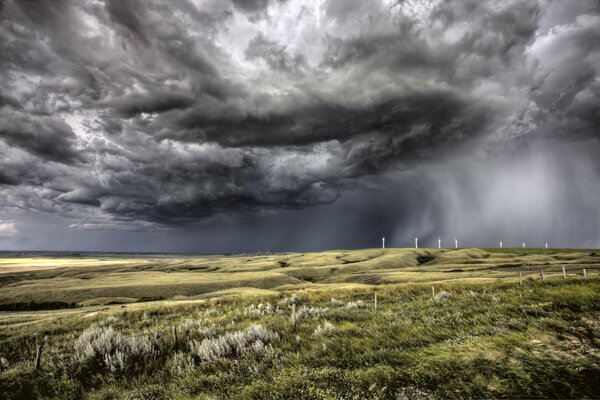 Black gloomy clouds in the field