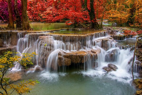 Rocky waterfall in the forest in autumn