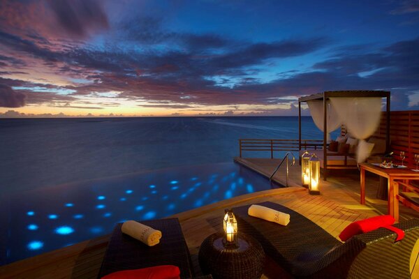 Romantic dinner on the shore of oken with candles and wine