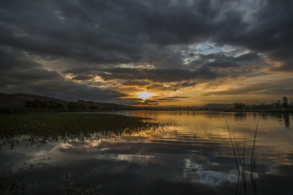 Dawn over the white lake in the clouds