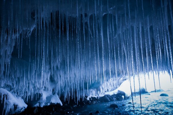 Cave in winter with numerous icicles