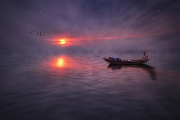 Splendida vista della barca galleggiante con i pescatori al tramonto