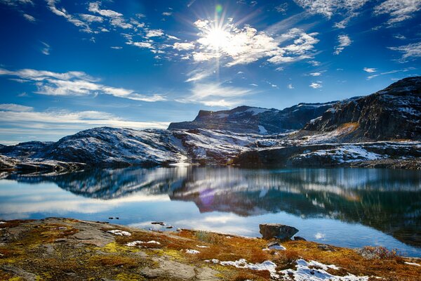 Snow-covered hills surrounded by icy water