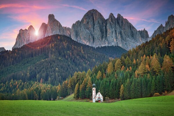 Temple on the background of sunset in the Alpine mountains