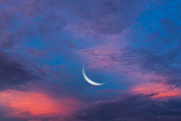 A bright moon in a dark purple sky