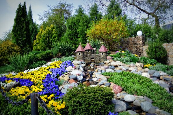 Petit château au milieu des pierres et des fleurs