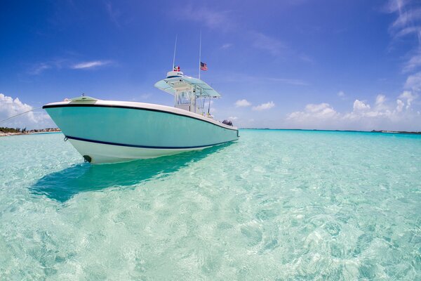 Clear blue ocean water and a beautiful yacht