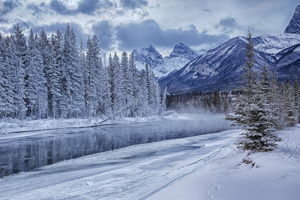 Snow-white winter fairy tale at the foot of the mountains