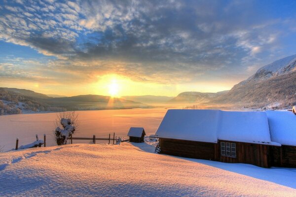 A wooden house is buried in snow