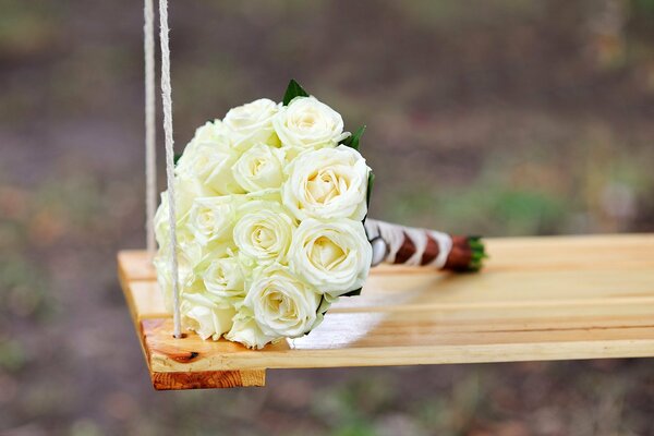 Bouquet of white roses on the swing