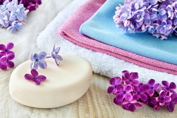 Lilac color. Soap, towel, flowers