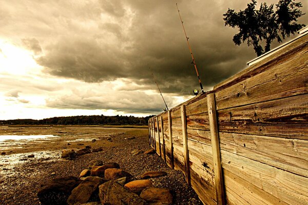 Fishing in the sea behind the fence