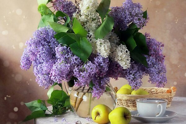 Still life with a bouquet of lilacs, apples and a cup