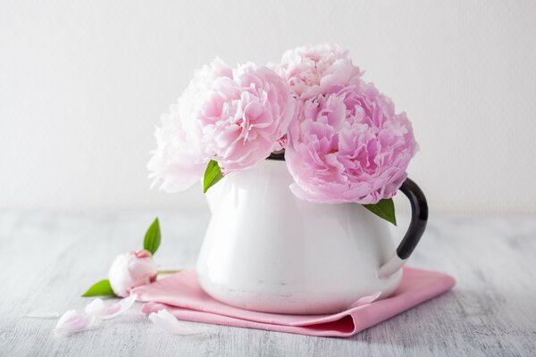 Delicate peonies in a vase on the table