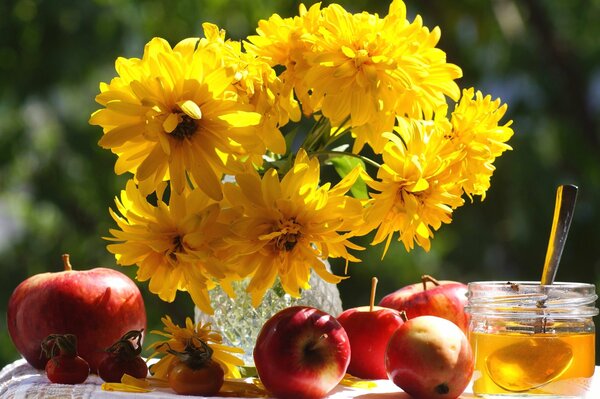 Apple honey spas and a vase with golden flowers