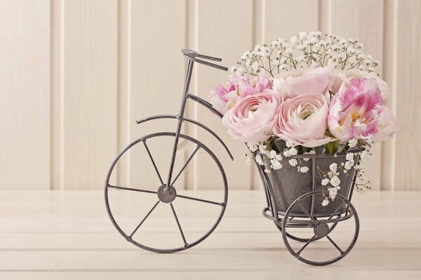 Roses in a vase in the shape of a bicycle